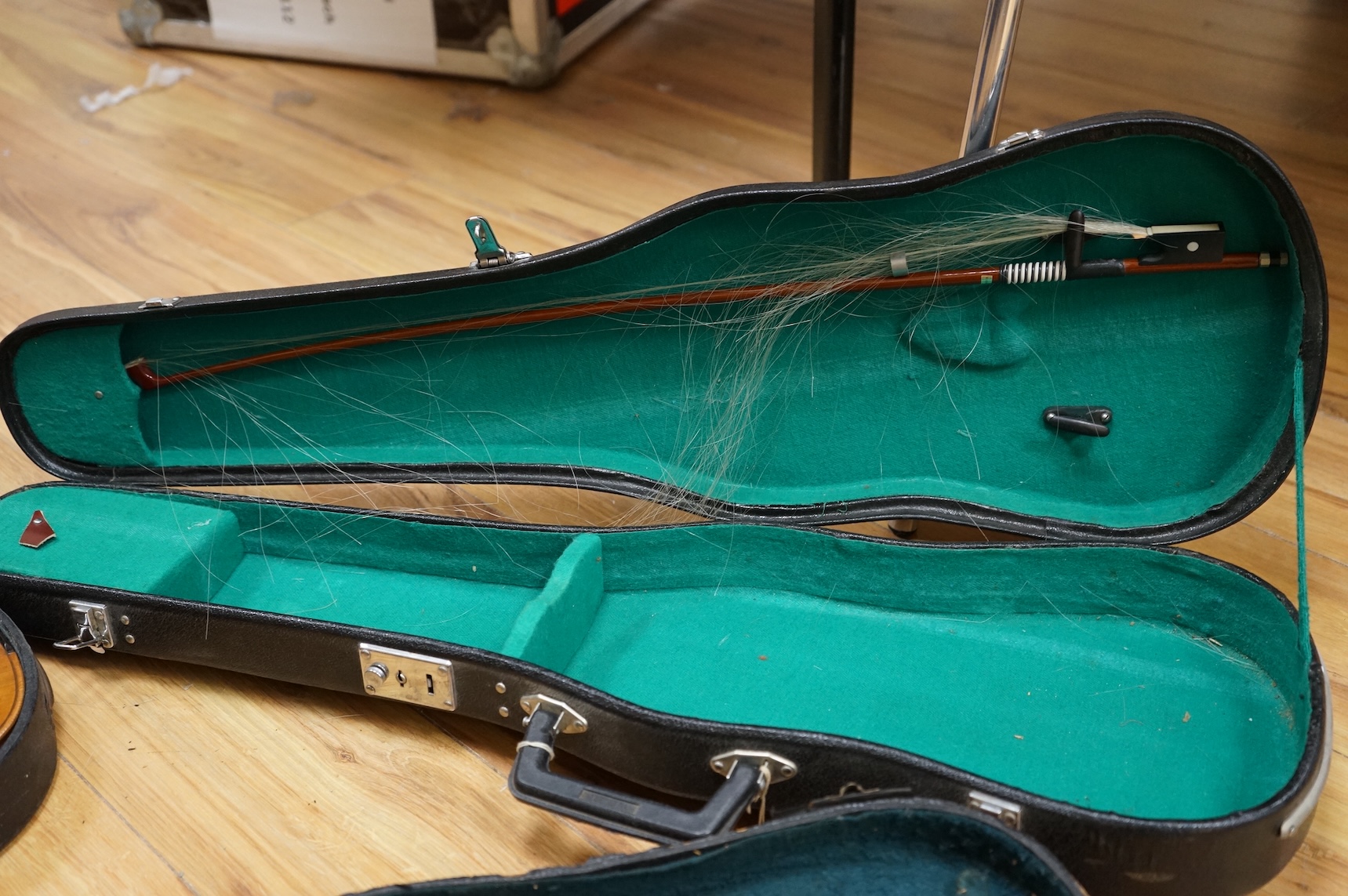 Three cased violins; a German Dresden violin, supplied by Campbell and co., Glasgow, together with another Dresden Stradivarius copy, and the remains of a European violin.